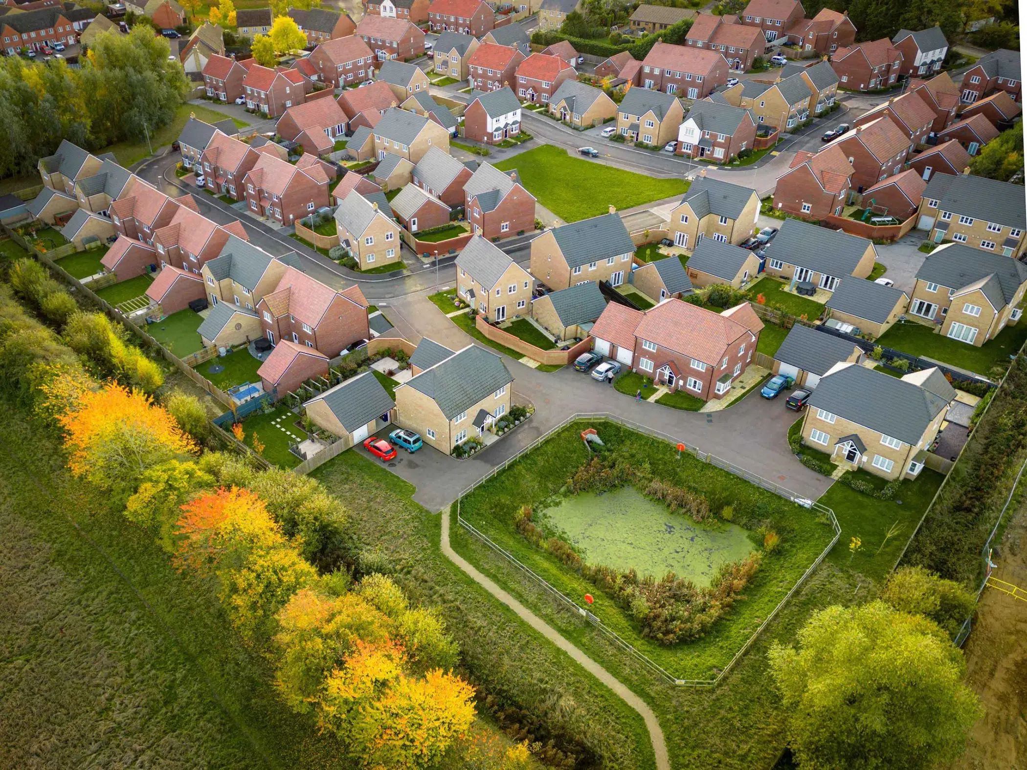Colecar Strategic Land, About us page, showing an aerial photo of a new housing development.